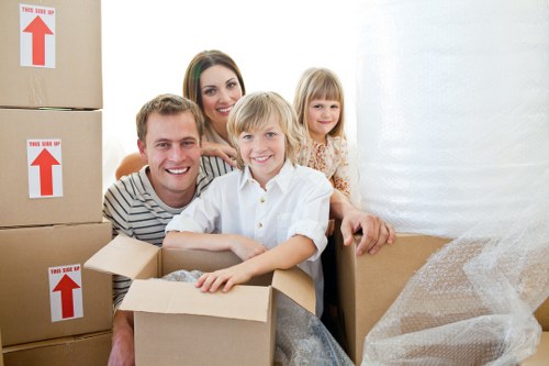 Removalists carrying furniture from a Balham flat with stairs