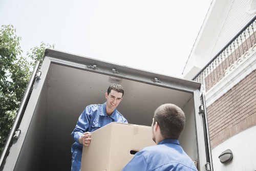 Removal crew handling a carefully wrapped household item