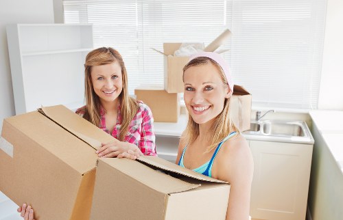 Professional furniture pick-up team handling stairs in Balham